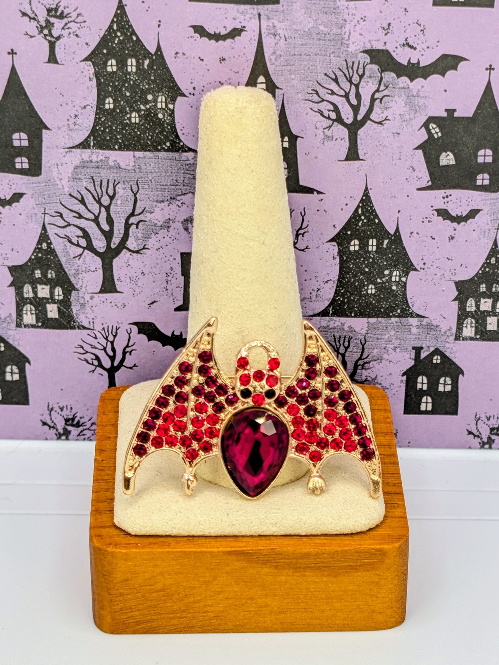 Gold-Tone Bat Brooch with Deep Red and Ruby Accents